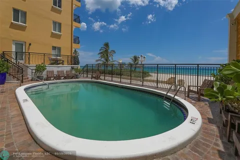 a view of a swimming pool with a outdoor seating