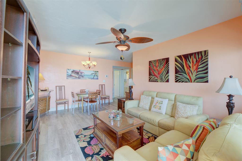 1815 North Surf Road, Unit 403 Hollywood, FL 33019 - Photo 3 of 28 a living room with furniture a rug and a chandelier
