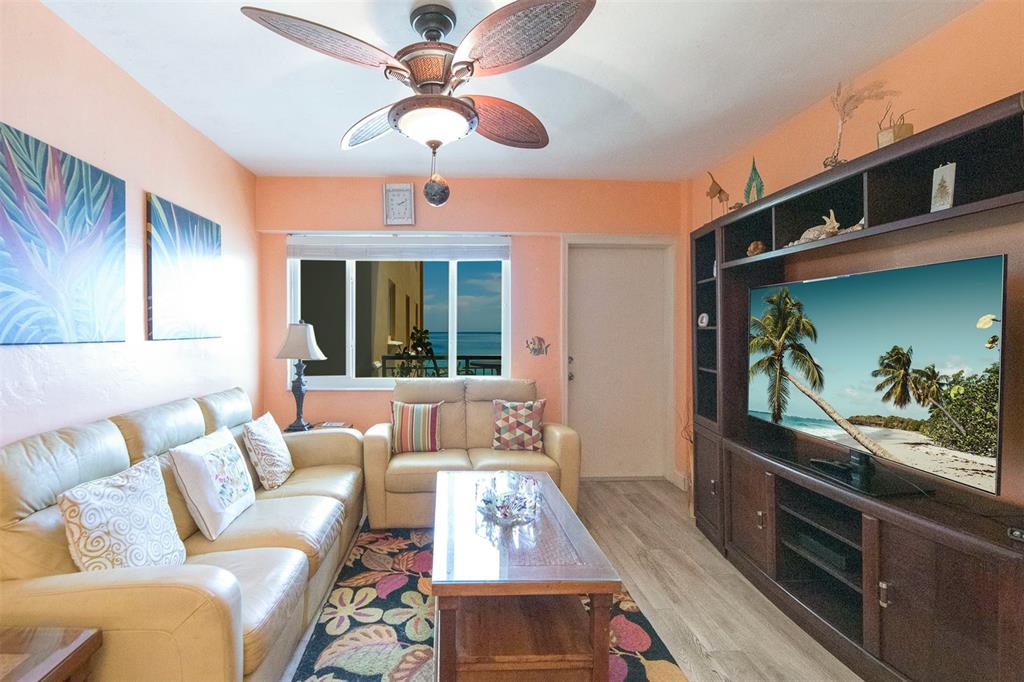 1815 North Surf Road, Unit 403 Hollywood, FL 33019 - Photo 5 of 28 a living room with furniture and a flat screen tv