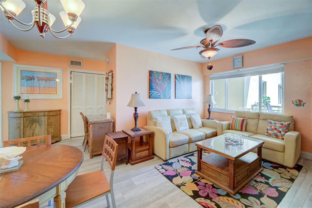 1815 North Surf Road, Unit 403 Hollywood, FL 33019 - Photo 6 of 28 a living room with furniture a chandelier and a dining table