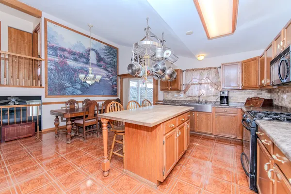 a living room with furniture a rug and a chandelier