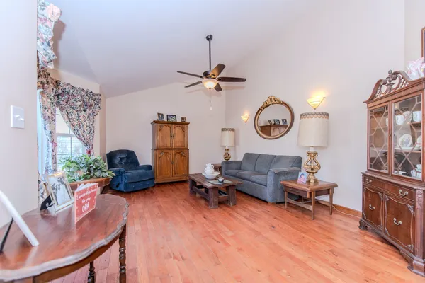 a living room with furniture and a wooden floor