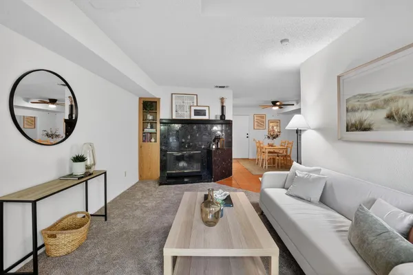 a living room with furniture and a mirror