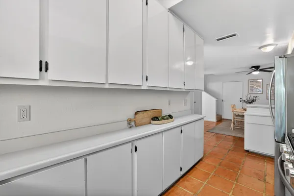 a kitchen with stainless steel appliances granite countertop a sink and dishwasher a stove top oven with white cabinets