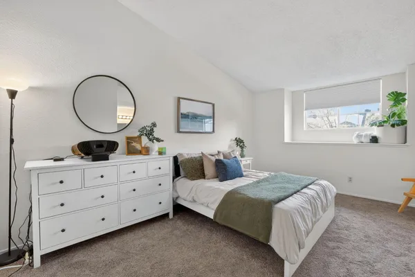 a bedroom with a bed and a dresser