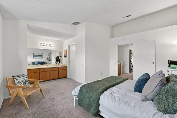 a bed room with a bed and a chair