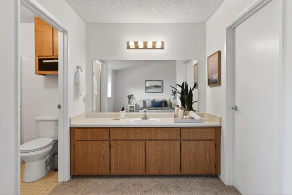 a en suite bathroom with a toilet sink and mirror
