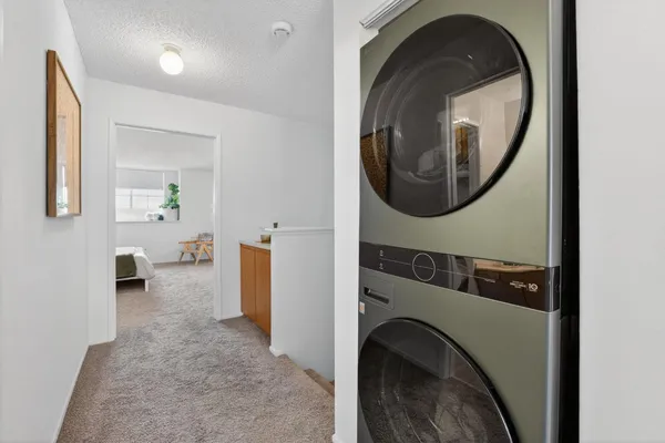 a view of a hallway with washer and dryer
