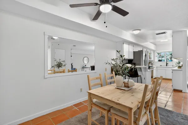 a view of a dining room with furniture and chandelier