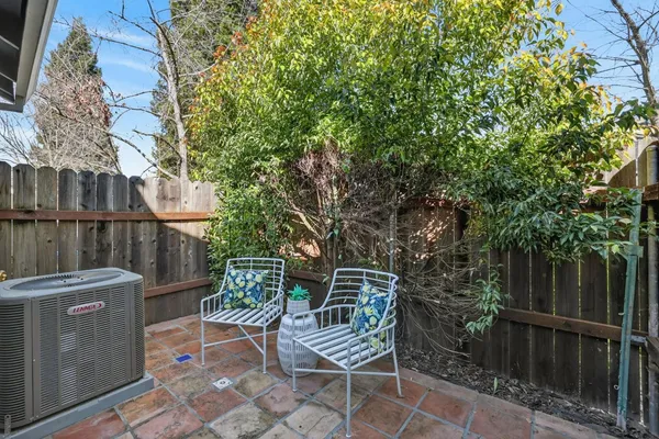 a view of a chair and table in the backyard