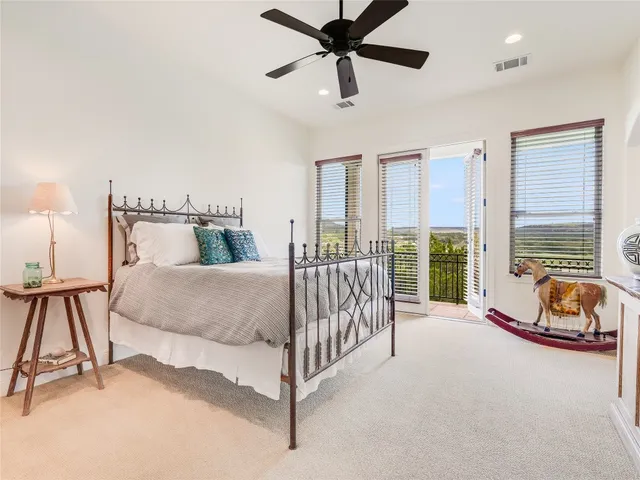 a spacious bedroom with a bed and a large window