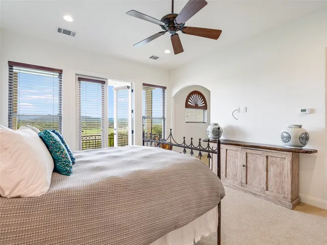 a view of a bedroom with furniture and windows