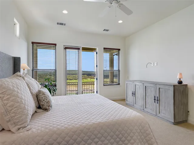 a bedroom with a large bed and a large window