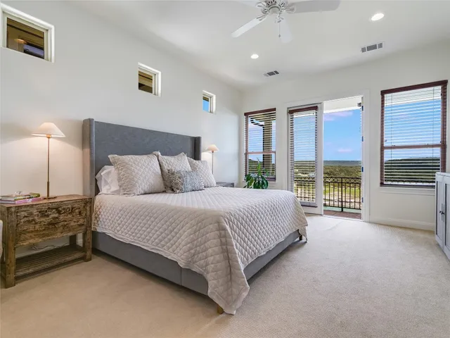 a spacious bedroom with a bed and a chandelier