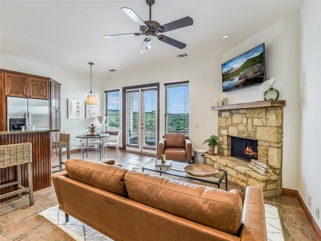 a living room with fireplace furniture and a flat screen tv