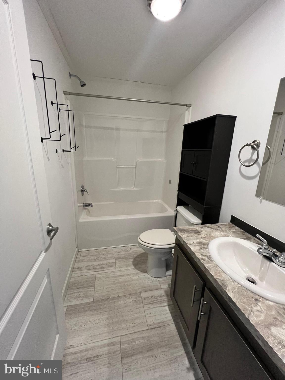 485 Keith Court Lothian, MD 20711 - Photo 11 of 23 a bathroom with a granite countertop sink toilet and shower