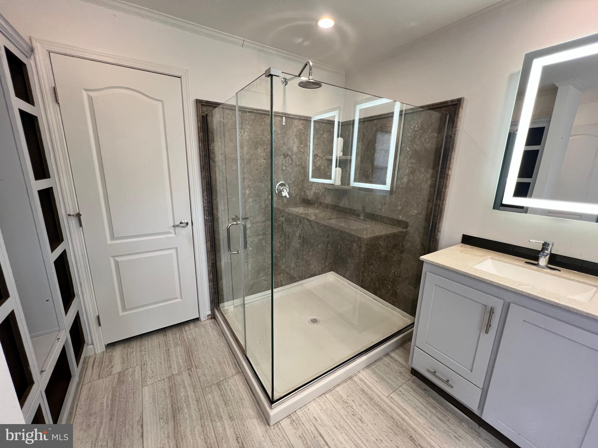 485 Keith Court Lothian, MD 20711 - Photo 16 of 23 a bathroom with a granite countertop sink mirror and shower
