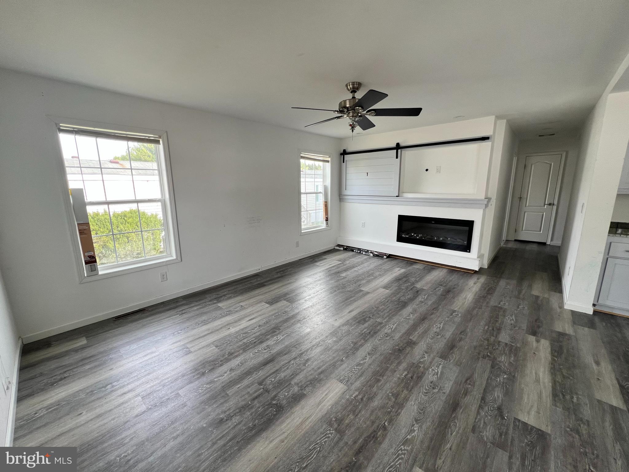 485 Keith Court Lothian, MD 20711 - Photo 3 of 23 a view of an empty room with wooden floor fireplace and a window