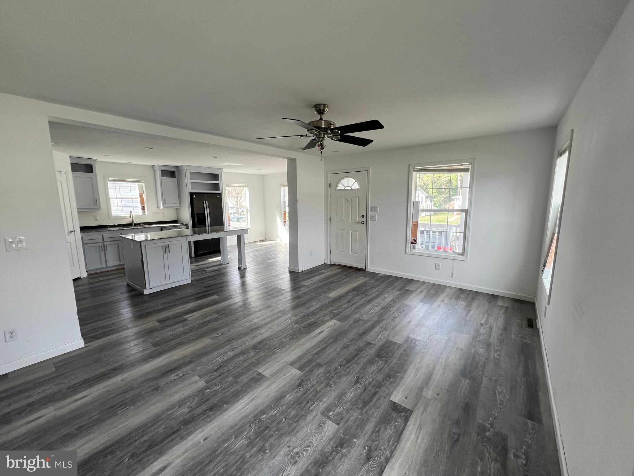 485 Keith Court Lothian, MD 20711 - Photo 5 of 23 an empty room with wooden floor a ceiling fan and windows