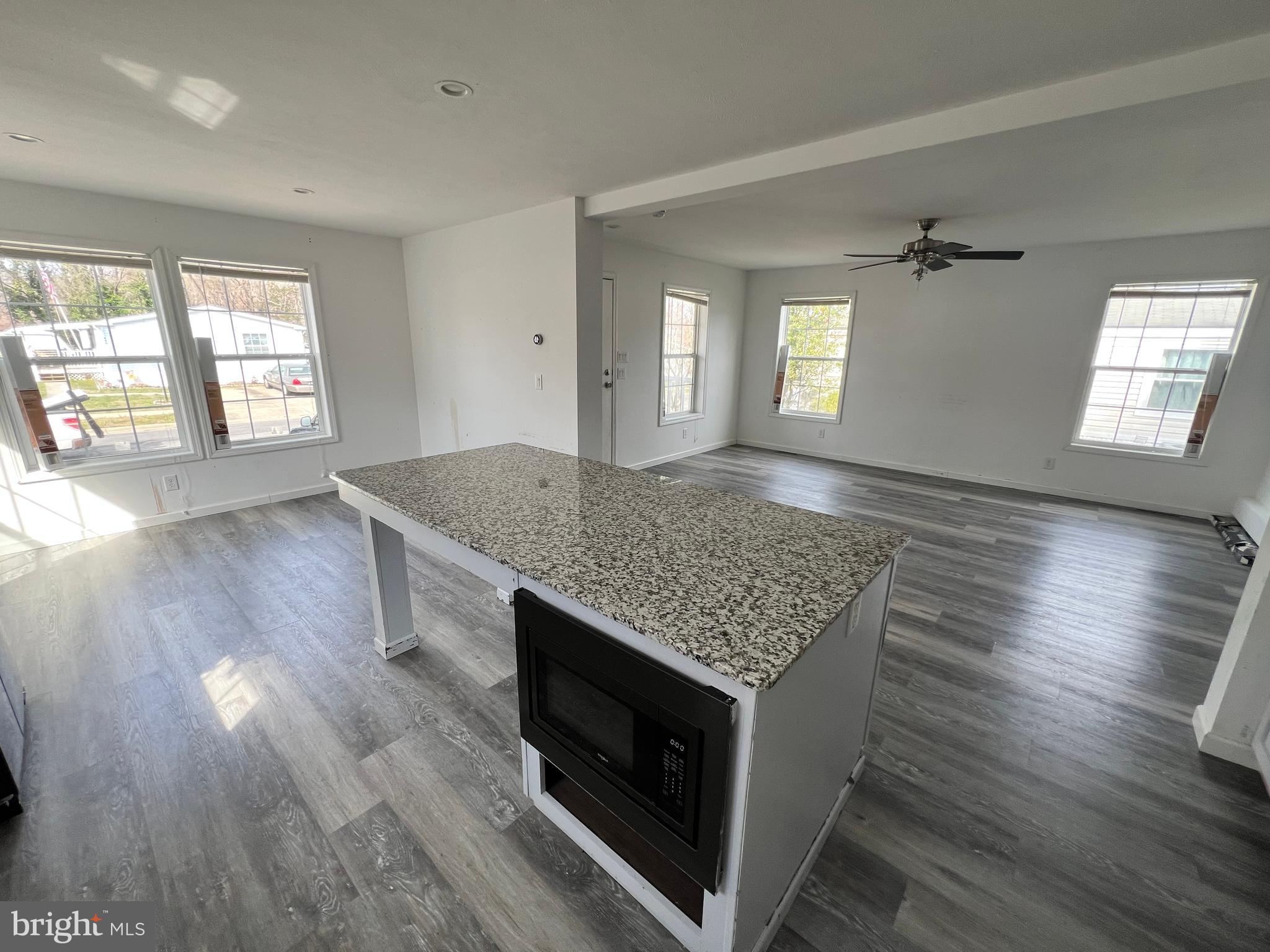485 Keith Court Lothian, MD 20711 - Photo 6 of 23 an empty room with wooden floor and cabinet