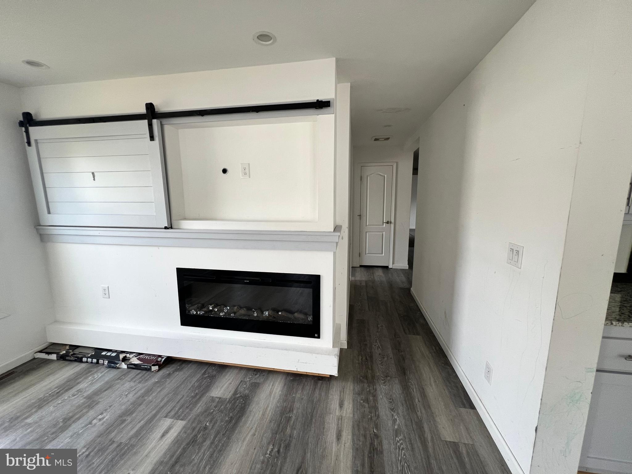 485 Keith Court Lothian, MD 20711 - Photo 10 of 23 a view of an empty room with wooden floor and a window
