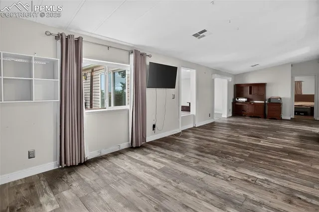 a view of livingroom with hardwood floor and workspace