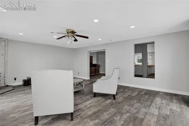 a living room with furniture and white walls