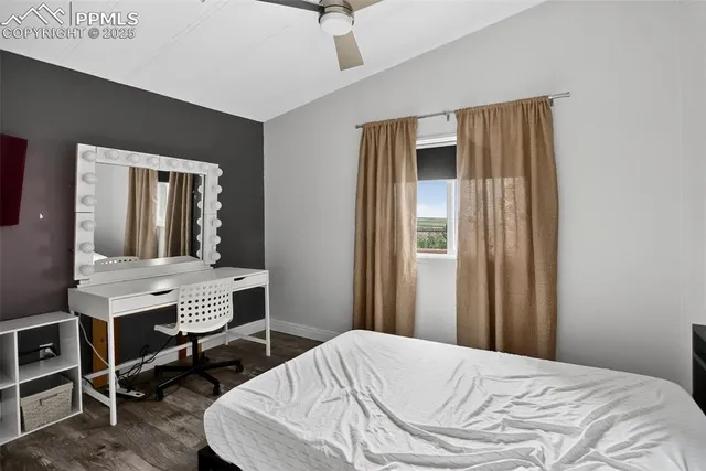 a bedroom with a bed and a table in it