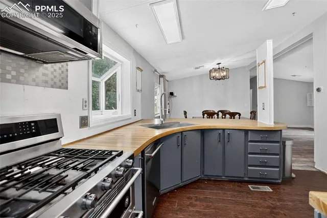 a kitchen with wooden cabinets and a stove top oven