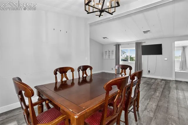 a view of a a dining room with furniture window and wooden floor
