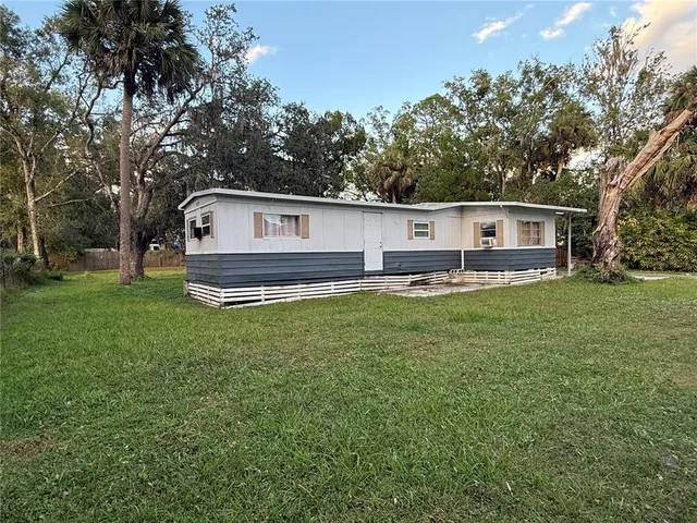 a front view of house with yard and trees