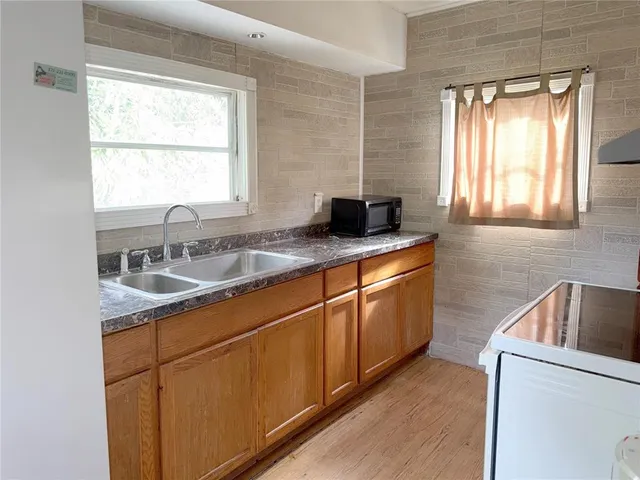 a kitchen with stainless steel appliances granite countertop a sink stove and cabinets