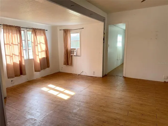 a view of empty room with floor to ceiling window