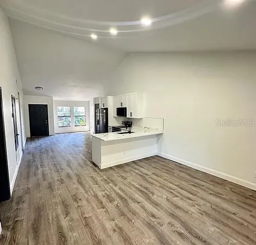 a living room with fireplace furniture and a wooden floor