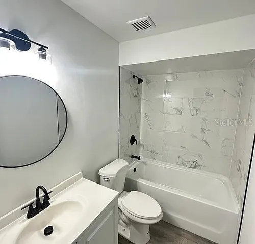 a bathroom with a sink toilet and shower