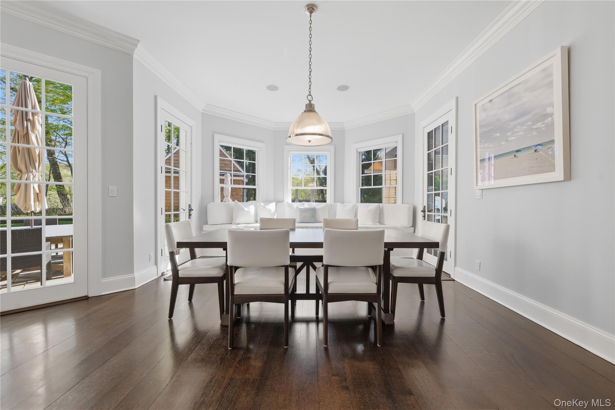 16 Wrights Mill Road Armonk, NY 10504 - Photo 18 of 49 a dining room with wooden floor a chandelier a wooden table and chairs
