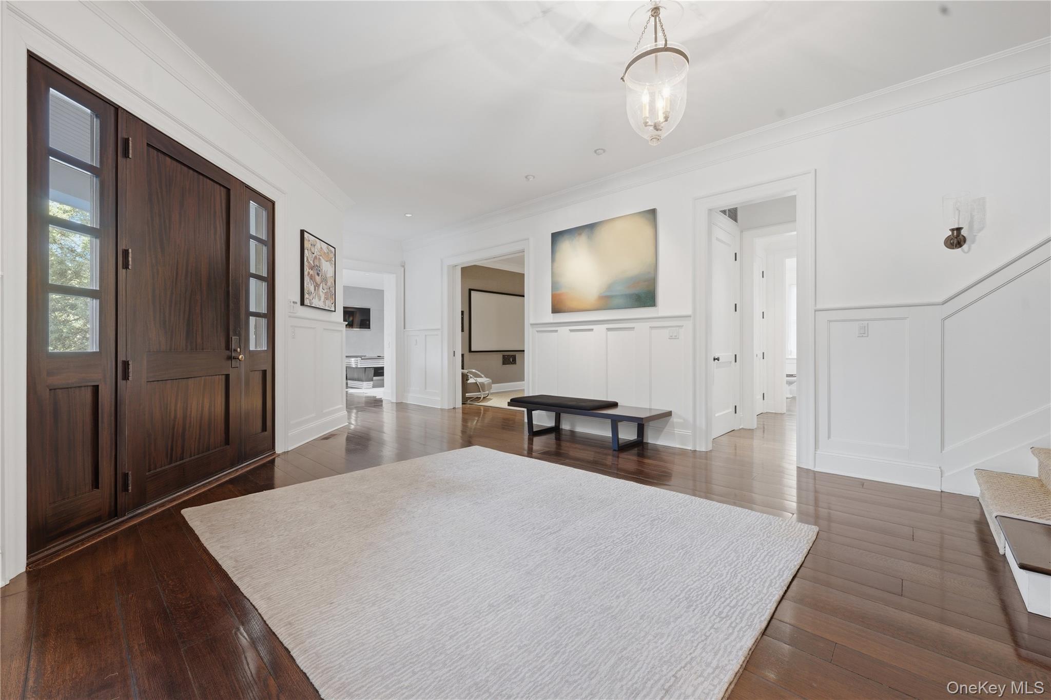 16 Wrights Mill Road Armonk, NY 10504 - Photo 5 of 49 a spacious bedroom with a bed and a chandelier