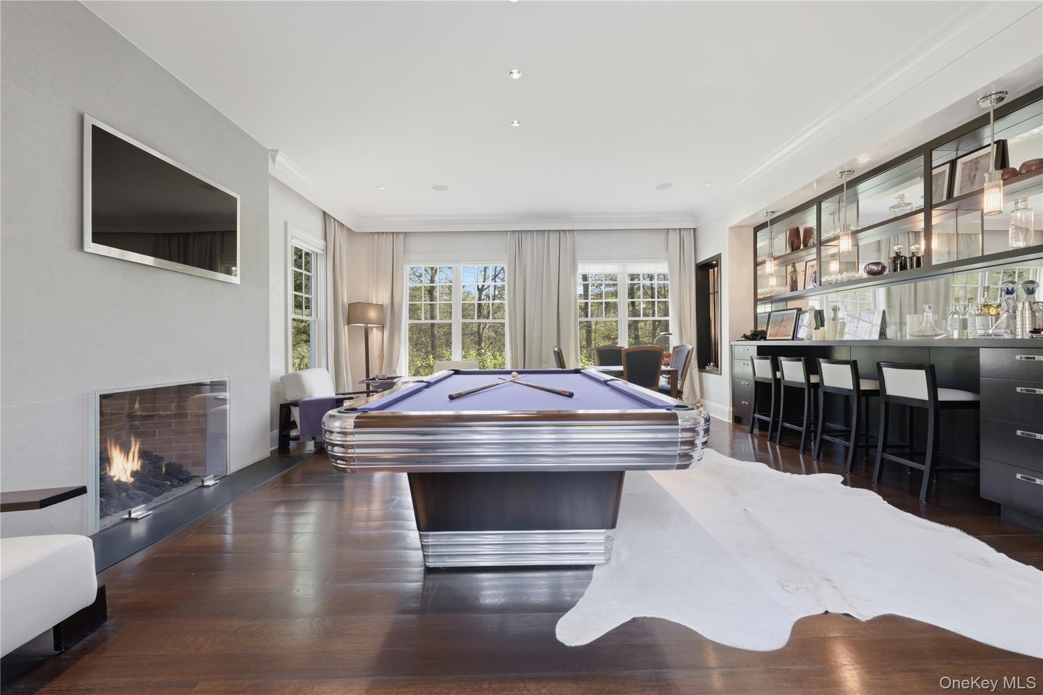 16 Wrights Mill Road Armonk, NY 10504 - Photo 9 of 49 a room with furniture a flat screen tv and a fireplace