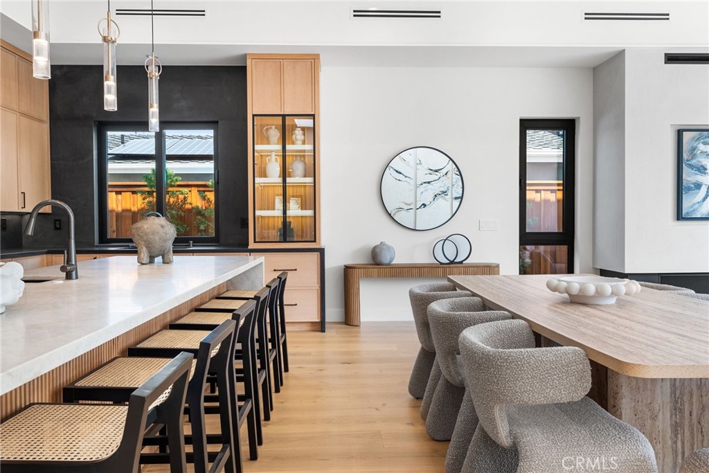 1206 Pembroke Lane Newport Beach, CA 92660 - Photo 11 of 49 a living room with furniture a clock and a large window