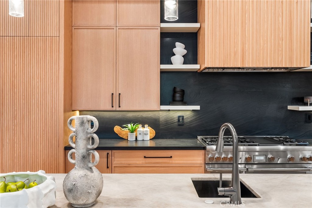 1206 Pembroke Lane Newport Beach, CA 92660 - Photo 12 of 49 a kitchen with a sink a stove and cabinets