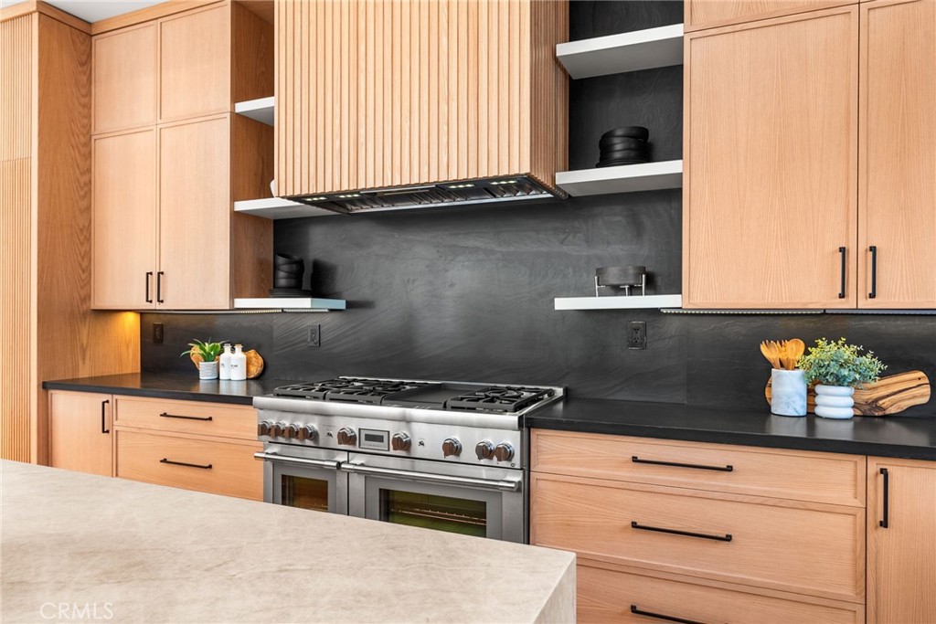 1206 Pembroke Lane Newport Beach, CA 92660 - Photo 15 of 49 a kitchen with stainless steel appliances granite countertop a stove and a microwave