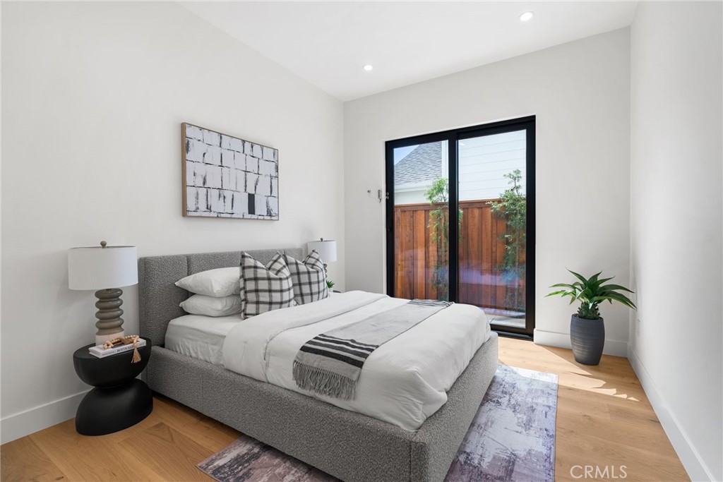 1206 Pembroke Lane Newport Beach, CA 92660 - Photo 42 of 49 a bedroom with a bed and a potted plant