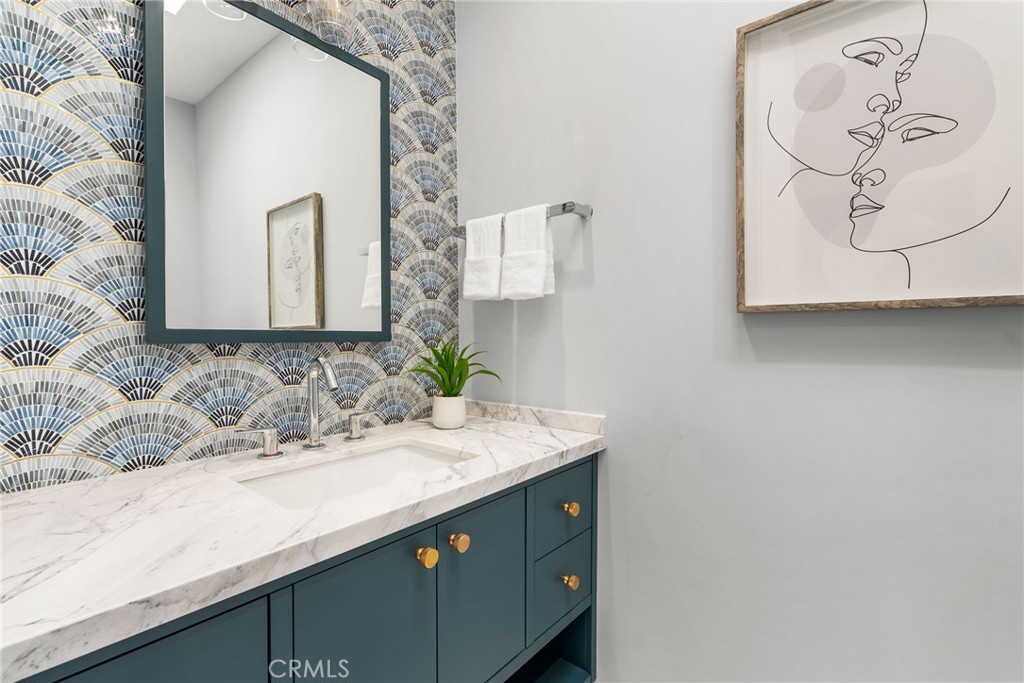 1206 Pembroke Lane Newport Beach, CA 92660 - Photo 43 of 49 a bathroom with a sink and mirror