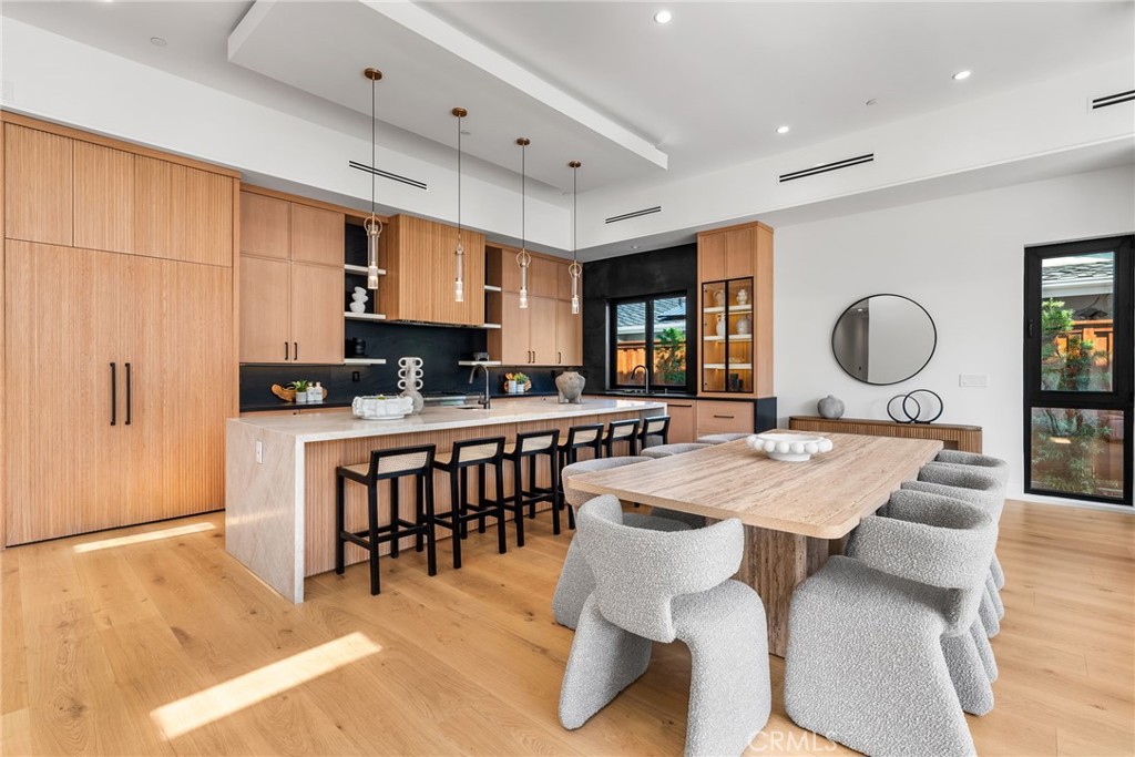 1206 Pembroke Lane Newport Beach, CA 92660 - Photo 8 of 49 a large kitchen with a table and chairs