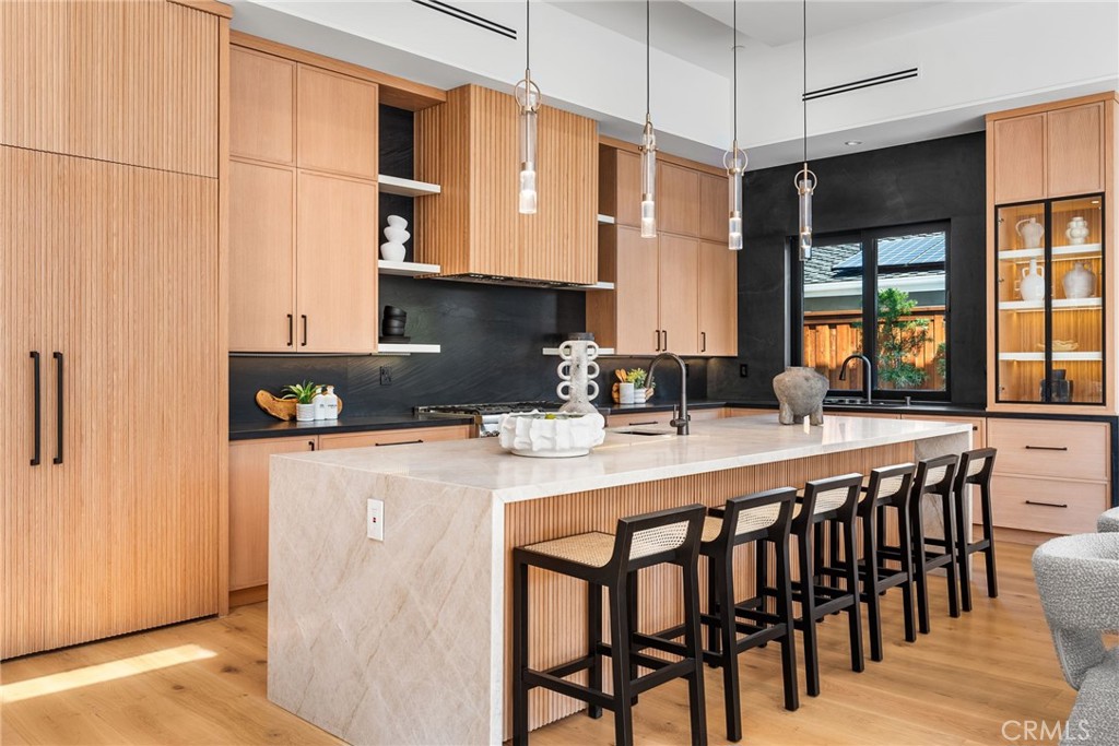 1206 Pembroke Lane Newport Beach, CA 92660 - Photo 9 of 49 a kitchen with stainless steel appliances granite countertop a stove a refrigerator a kitchen island a dining table and chairs with wooden floor