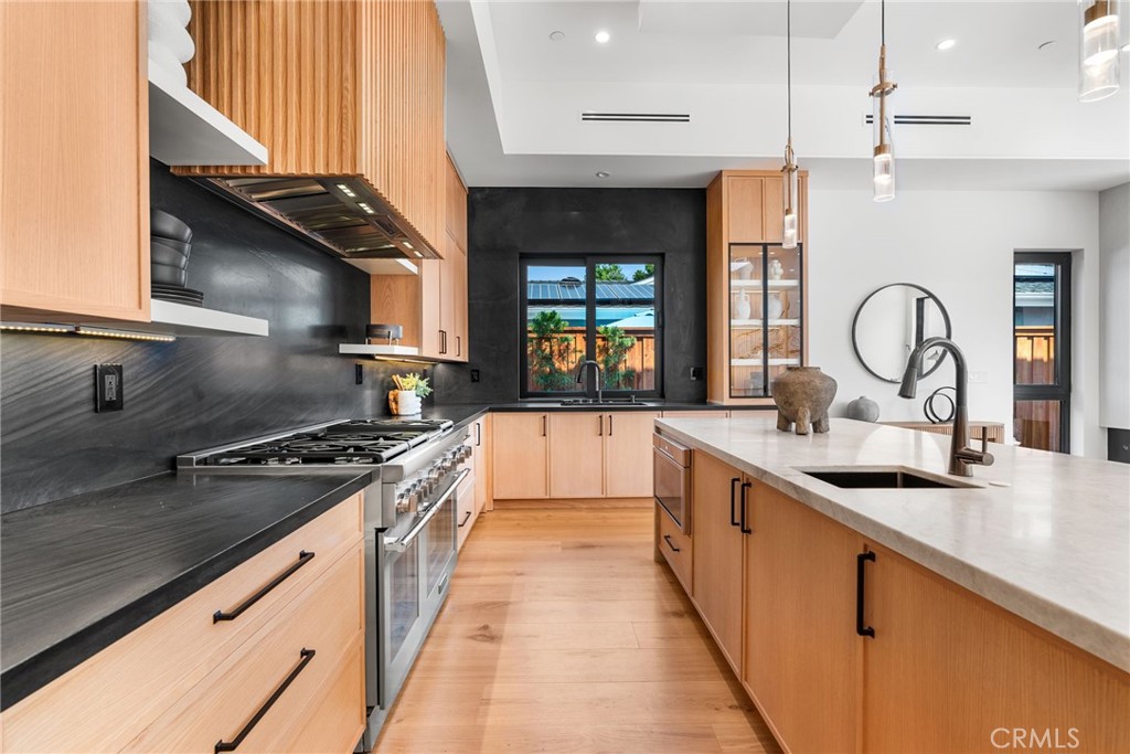 1206 Pembroke Lane Newport Beach, CA 92660 - Photo 10 of 49 a kitchen with stainless steel appliances granite countertop a sink and a stove