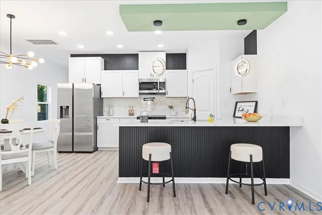 a kitchen with stainless steel appliances granite countertop a refrigerator and microwave