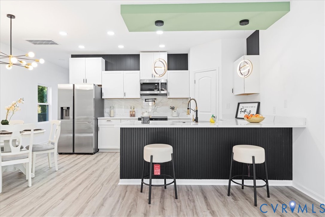 731 Harding Street Petersburg, VA 23803 - Photo 12 of 44 a kitchen with stainless steel appliances granite countertop a refrigerator and microwave