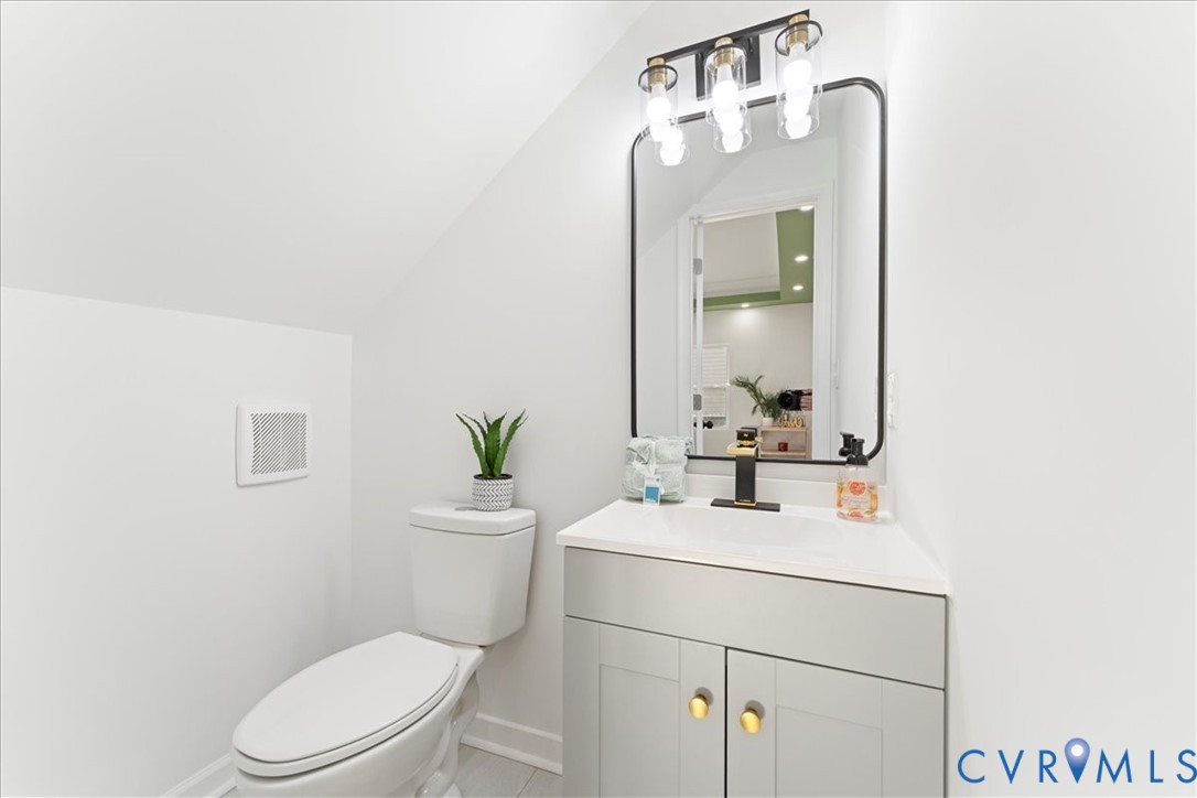 731 Harding Street Petersburg, VA 23803 - Photo 17 of 44 a bathroom with a toilet a sink and mirror