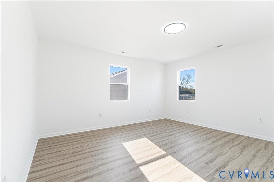 731 Harding Street Petersburg, VA 23803 - Photo 26 of 44 an empty room with wooden floor and windows
